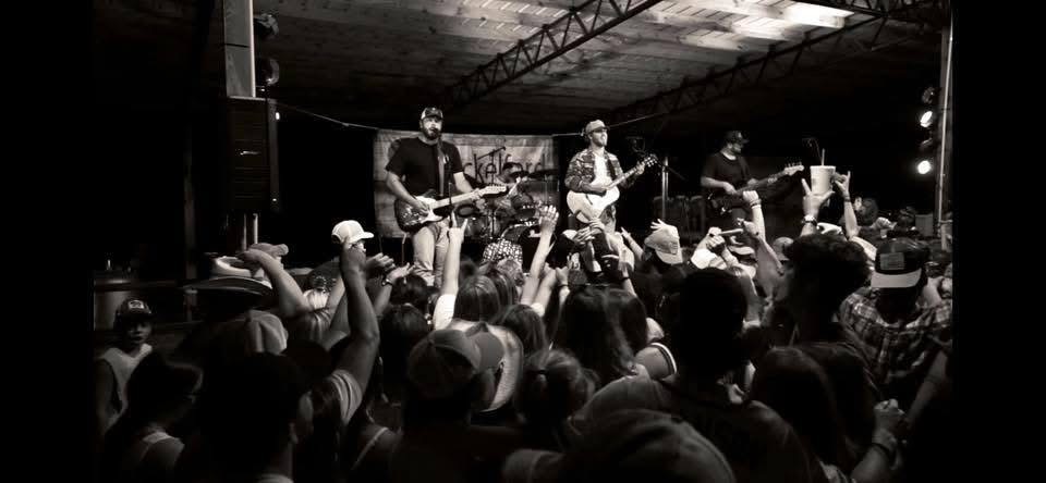 Black and white crowd shot with hands up